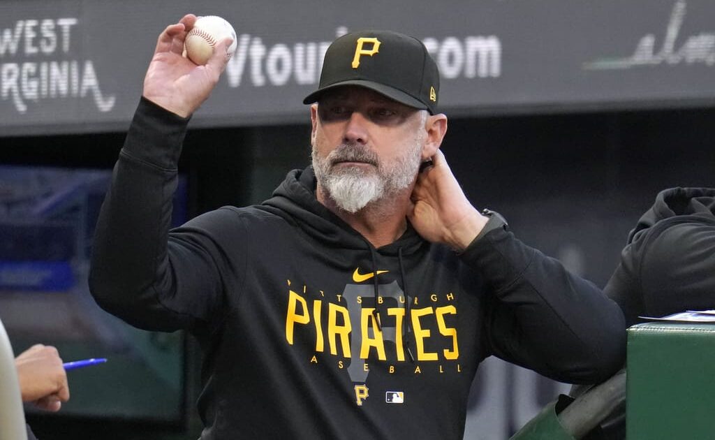 Pittsburgh Pirates manager Derek Shelton tosses a foul ball to a fan during the first inning of the team's baseball game against the Washington Nationals in Pittsburgh, Wednesday, Sept. 13, 2023. (AP Photo/Gene J. Puskar)